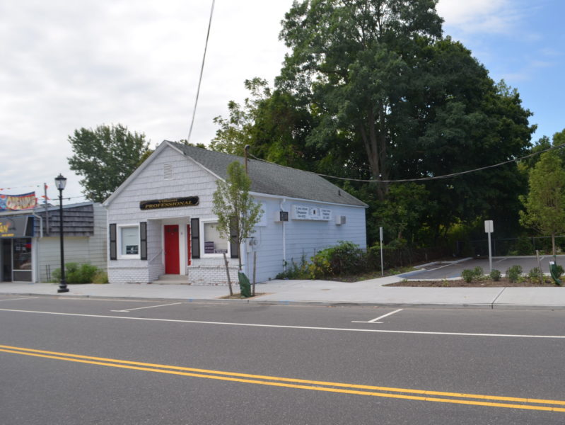 front of retail building on street for sale at maltz auctions