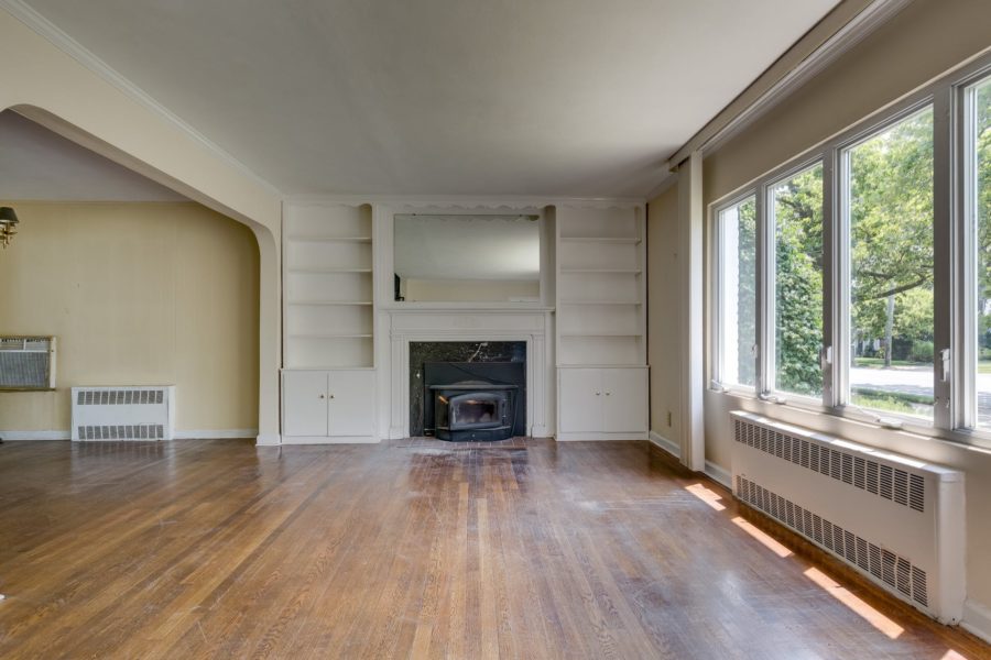 fireplace, mantel, and front windows of 4 bedroom home for sale at maltz auctions
